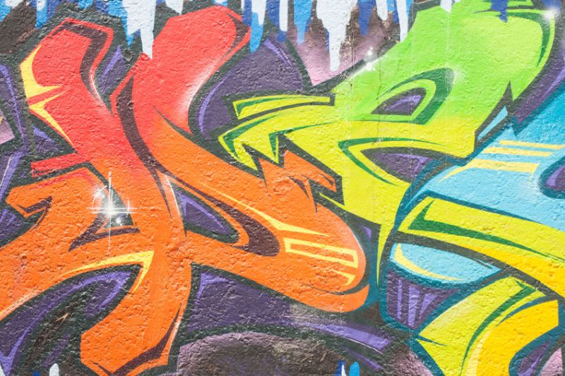 46735066 - colourful drawing of graffiti on concrete wall