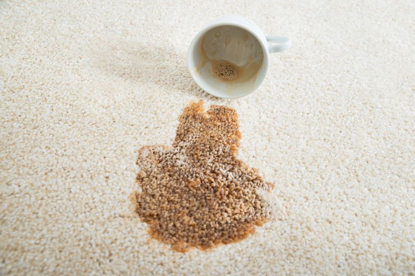 47217464 - close-up of coffee spilling from cup on carpet