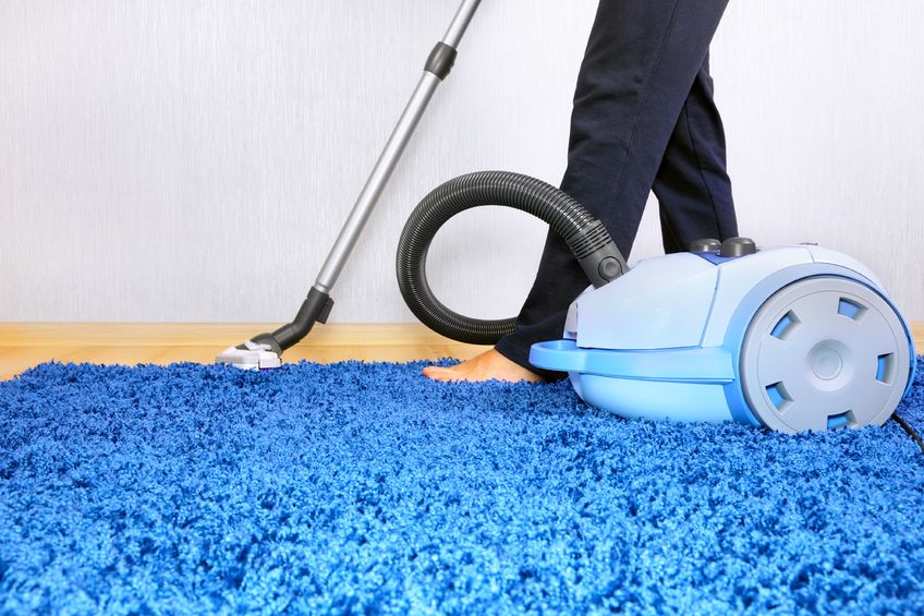 11924706 - powelful vacuum cleaner in action-a men cleaner a carpet.