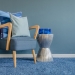 37699196 - wooden chair with blue color pillow on carpet in living room