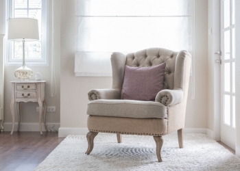 47365036 - classic chair on carpet with pillow in bedroom